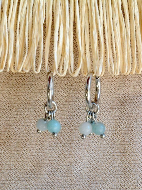 Aretes Belai Amazonita Trio, argollas de acero con racimo de tres cuentas redondas de amazonita celeste, apoyados sobre fibra de rafia y lino